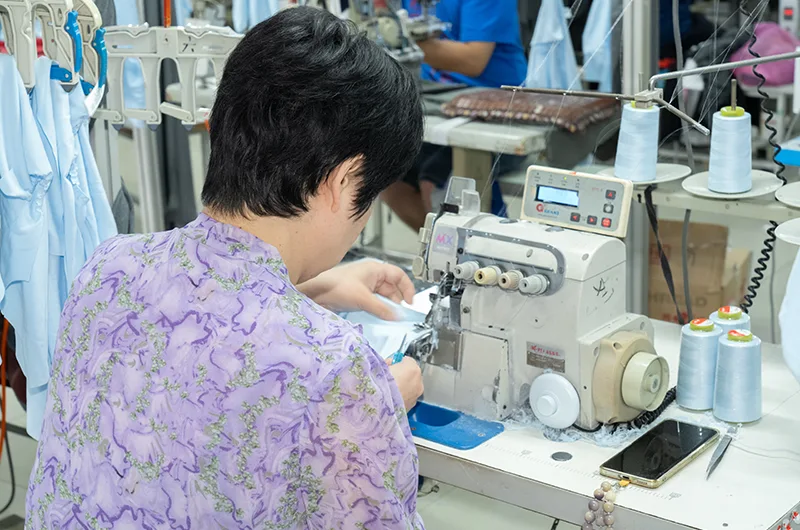 Close-up of an experienced operator using an industrial sewing machine